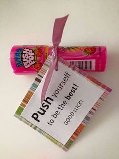 two candy bars tied to each other with a pink ribbon and tag that says push yourself