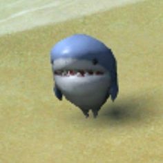 an animated shark with its mouth open on the beach