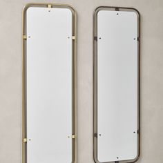 two mirrors on the wall next to each other, one is gold and the other is white