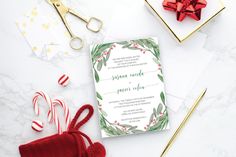 the wedding stationery is surrounded by candy canes and other holiday decorations, such as candies