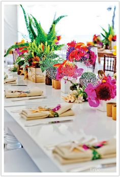 the table is set with napkins and flowers