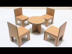 four chairs and one table made out of cardboard