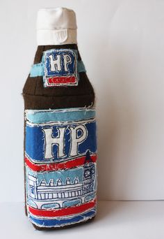 a brown and blue bottle with the word hip on it sitting next to a white wall