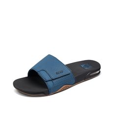 PRICES MAY VARY. MEN'S FANNING SLIDE: Reef's easy on, easy off slide with a bottle opener in the sole of the sandal. They are handcrafted with a comfortable footbed and anatomical arch support. BOTTLE OPENER: Use the church key bottle opener integrated into the rubber outsole giving you thirst quenching technology (TQT) on the go. REEF is the only men's sandal with a bottle opener. ARCH SUPPORT: Anatomical arch support slides for men give you a refreshing feel of satisfaction every time you slip Slides For Men, Absorbing Man, Key Bottle Opener, Men Slides, Athletic Trainer, Flat Shoe, Synthetic Rubber, Athletic Fashion, Mens Fashion Shoes