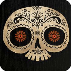 a white sugar skull with orange eyes on a black wooden background, decorated with flowers and leaves