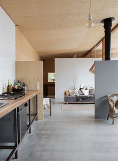 an open kitchen and living room with wood paneling