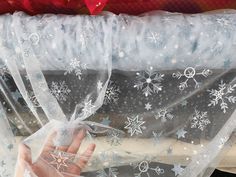 a person's hand is wrapped in plastic with snowflakes on it