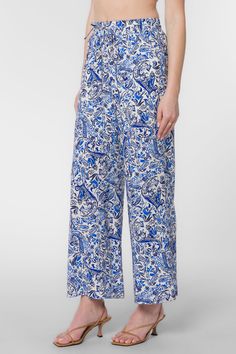 Looking for a fresh and fashion-forward look? These stylish pants feature a pull-on style, wide legs, an elastic drawstring waist, and side pockets. So whether you're dressing up or dressing down, these pants are sure to keep you looking your best. Material: 100% Viscose Machine wash cold, tumble dry low Color: Blue Paisley Model is 5'9" and wearing a size S Imported Summer Wide-leg Paisley Print Pants, Spring Wide-leg Pants With Paisley Print, Spring Wide Leg Bottoms With Paisley Print, Spring Paisley Print Trousers, Wide Leg Bottoms With Paisley Print For Spring, Paisley Print Trousers For Spring, Wide Leg Paisley Print Bottoms For Spring, Blue Paisley Print Bottoms For Vacation, Paisley Print Blue Bottoms For Vacation