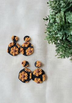 Sunflower earrings are the perfect fall earrings! These polymer clay earrings have yellow/orange petals on a black background. These drop, statement sunflower earrings are a great everyday earrings. Each earring is extremely lightweight.  These boho polymer clay earrings are handmade and perfect for gifts! These are hypoallergenic earrings, and the earring post is made of stainless steel, and the jump ring is made of iron. Enjoy these cute sunflower earrings! Handmade Black Polymer Clay Earrings, Fall Clay Earrings, Clay Earrings Black, Boho Polymer Clay, Cute Sunflower, Boho Earring, Sunflower Earrings, Earring Post, Fall Earrings