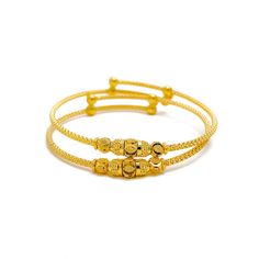 This pair of 22k gold baby bangles is both charming and ornate, offering a delicate design that exudes timeless beauty. Weighing a total of 9.4 grams, these bangles feature a radiant yellow gold finish with a 1.75-inch diameter. The adjustable design ensures a perfect fit as your child grows. The intricate detailing adds a touch of elegance, making this two-piece set an ideal gift that combines tradition with refined craftsmanship. Perfect for creating lasting memories, these bangles are a precious keepsake for any special occasion. PRODUCT DETAILS Gold Purity(karat): 22k Gold Weight(grams): 9.4 Item Finish: Yellow Gold Bangle Diameter: 1.75" Adjustable Bangle: Yes Number of Pieces: 2 Bangles Festive 22k Yellow Gold Bangle, Adjustable Yellow Gold Bracelet With Intricate Design, Traditional 22k Yellow Gold Bracelets, Traditional Gold-plated Yellow Gold Bracelet, Festive Yellow Gold Bangle Bracelet, 22k Yellow Gold Bracelet With Intricate Design, Intricate 22k Yellow Gold Bracelet, Gold Plated Bangle With Intricate Design In Yellow Gold, Adjustable Yellow Gold 22k Bangle