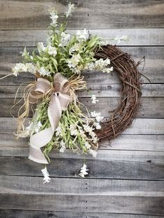 a wreath with white flowers tied to it