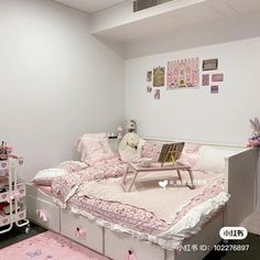 a bedroom with pink and white decor on the walls, bedding and rugs