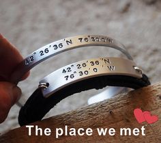 two bracelets that say the place we met on each side and have numbers engraved on them