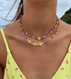 Smiley Face Necklace, Rainbow happy face necklace, multicolor seed bead necklace w/ pearls, beaded necklace, emoji necklace, layering necklace perfect necklace for a beach day or everyday wear! water resistant. this necklace is perfect for everyday wear. all jewelry is handmade.  * handmade jewelry * length: 14-16 inches long with adjustable length  * material: seed beads, pearls, rubber faces *light weight  * Closure: Lobster Claw * chain style: bead * adjustable length  **you can choose between a necklace with 1 or 3 smiley beads & w/without pearls Fun Festival Beaded Necklace With Letter Beads, Fun Round Bead Necklaces For Summer, Fun Summer Necklaces With Round Beads, Beach Jewelry With Smiley Face Round Beads, Fun Summer Jewelry With Smiley Face, Fun Smiley Face Jewelry For Summer, Fun Smiley Face Summer Jewelry, Fun Summer Beaded Necklaces With Round Beads, Fun Colorful Beaded Necklaces For Summer