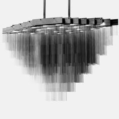 a black and white photo of a chandelier hanging from the ceiling with lights