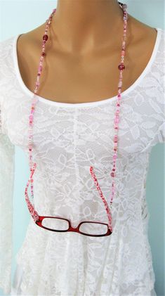 "This Pink Eyeglass Chain can also be worn as a necklace. Ralston Originals was the first to add the lobster clasp at the end of the eyeglass chain to join it together to make a Necklace. Brilliant! This makes it even more convenient because you now have two pieces of jewelry in one, and eyeglass chain for your glasses, and a beaded necklace!! The chain is made with an assortment of sizes and colors of pretty pink glass beads, and pink seed beads. The ready made chain is 26 or 32 inches long, or Eyeglass Holder Necklace, Lanyard Pink, Beaded Glasses Chain, Beaded Eyeglass Chain, Beaded Glasses, Pink Eyeglasses, Make A Necklace, Chain For Women, Eyeglass Holder