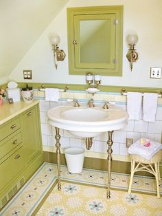 a white sink sitting under a bathroom mirror next to a green cabinet and counter top