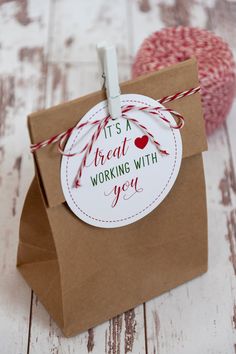 a brown paper bag with a red and white tag on it