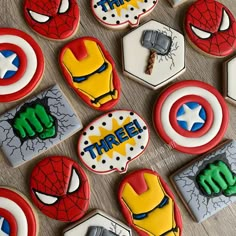 decorated cookies are arranged in the shape of superheros