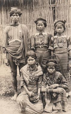 an old black and white photo of people in native american dress standing next to each other