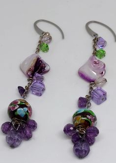 Pretty purple combination of glass, acrylic, and mother of pearl earrings. Approximately 3" inches in length. Ear hooks are surgical steel. Purple Czech Glass Earrings For Gift, Nickel-free Purple Glass Jewelry, Adjustable Purple Beaded Earrings With Colorful Beads, Purple Dangle Earrings With Beads, Purple Czech Glass Jewelry With Dangling Beads, Adjustable Purple Chandelier Drop Earrings, Purple Czech Glass Earrings With Dangling Beads, Purple Czech Glass Dangle Earrings, Bohemian Purple Earrings Made Of Czech Glass