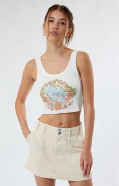 The Tropical Feelings Tank Top from Billabong is perfect for the warm weather. It features a Billabong dolphin graphic on the front, a raw cut hem, and a cropped fit.


	Solid color tank top
	Scoop neckline
	Fixed straps
	Billabong graphic
	Raw cut hem
	Cropped length
	Fitted
	100% cotton
	Machine washable
	Model is wearing a size small
	Model measurements: 5’8.5” height, 31.5” bust, 24” waist, 35.5” hips Dolphin Graphic, Bedroom Stuff, Outfit Inspo Summer, Billabong Women, Top Graphic Tees, Fit Check, Cute Fits, White Tank Top, Summer Tops