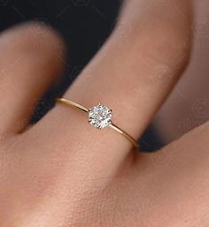 a woman's hand with a diamond ring on it