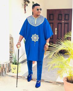 Authentic African AGBADA for men. Do you love wearing fashionable African outfits made of high quality fabrics with top notch tailoring? If yes, kindly place your orders for this Original AGBADA. We do for individuals, groups, couples and even families and cater to both males and females. All outfits are made to order for exact fit per customer wishes. This particular AGBADA comes in blue fabric with yellow embroidery design. The design is available in several colors so you can tell us your pref Men Agbada Styles, Agbada Styles Men, Agbada For Men, Agbada Outfit, Men African Wear, Mens Traditional Wear, Wedding Suit Styles, African Fashion For Men, Dashiki For Men