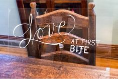 a wooden chair with the words love at first bite written on it