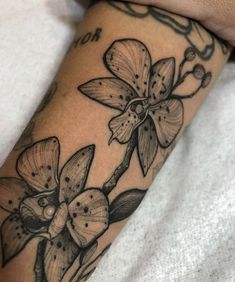 a close up of a person's arm with flowers on it