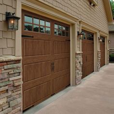 two brown garage doors on the side of a house