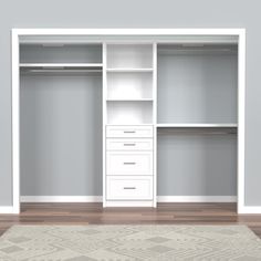 an empty white closet with drawers and shelves on the wall, in front of a rug