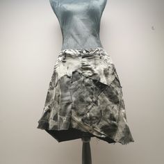 "Upcycled stretchy bleached black denim patchwork skirt. Frayed seams and jagged hem. Rear pockets and faux front pockets. Waist measures 36\" and length is approximately 19\"." Edgy Fitted Cotton Denim Skirt, Edgy Fitted Denim Skirt, Cotton Cutoff Grunge Denim Skirt, Cotton Cutoff Denim Skirt In Grunge Style, Cutoff Cotton Denim Skirt In Grunge Style, Grunge Cotton Cutoff Denim Skirt, Fitted Cotton Denim Skirt With Unfinished Hem, Fitted Cotton Cutoff Skirt, Fitted Denim Skirt With Unfinished Hem