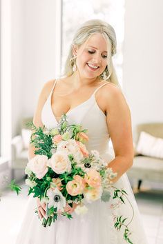 a woman in a wedding dress holding a bouquet