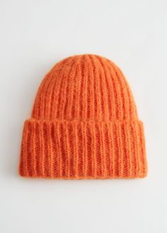 an orange knitted hat on a white background