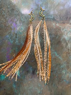 one pair of natural long feather earrings - bijoux de plume naturelle - feather jewelry made from natural grizzly, ginger and white rooster feathers. These are gold colored (not real gold) wire earrings with real turquoise chip beads that are wire wrapped around the crescent moon. These are 10 inches long and handmade by me. The drop length is about 10-11inches from earring lobe to longest feather. Turkey Feather Jewelry, Bohemian Dangle Feather Earrings, Bohemian Dangle Earrings With Feathers, Bohemian Brown Feather Jewelry, White Rooster, Earrings Feather, Earrings Moon, Rooster Feathers, Real Turquoise