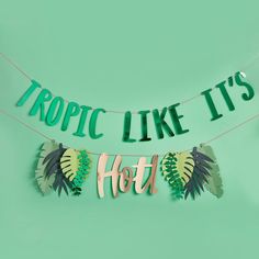 a banner that says tropic like it's hot hanging from a string