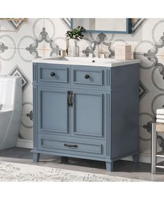 a bathroom vanity with a blue cabinet and white sink