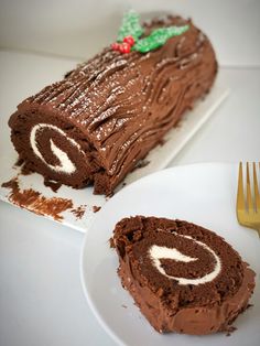 a piece of chocolate cake sitting on top of a white plate next to a fork