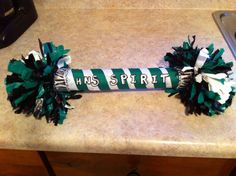 a green and white cheer pom - poms sitting on top of a counter