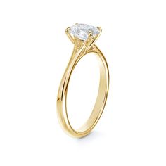 a yellow gold engagement ring with a single diamond