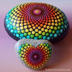 two painted rocks sitting next to each other