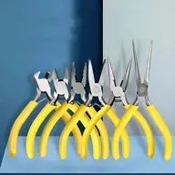 six pairs of scissors sitting next to each other on a blue counter top in front of a white wall