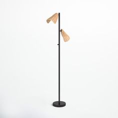 a floor lamp with two lamps on top of it and one light on the base