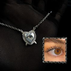 "Engraved Custom Lover's Eye Pendant Necklace  ~ (0.5\", sterling silver) 🗡human eyes only - please send clear photos showing the entire eye!    This sterling silver pendant features two intricately designed daggers that pierce through each side of the heart diagonally. The pendant is a little over 0.5\" in size. Inside of the heart can be engraved with your or your loved one's eye. These pendants are inspired the sentimental tradition of Victorian Lover's Eye, a tradition where couples (and se Symbolic Eye-shaped Silver Jewelry, Painted Portraits, Lovers Eyes, Human Eyes, Secret Lovers, Eye Pendant Necklace, Human Eye, Eye Pendant, Eye Necklace