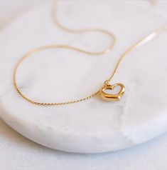 This is our super cute reversible heart pendant necklace. It's got a dope shell design on one side and gold on the other - so you can switch it up to match any outfit. The pendant is made from stainless steel that's been plated with 18k gold for a super luxe vibe. It's basically the perfect accessory to add some extra sparkle to your look. ⊹ Materials ⊹ High Quality 18k Gold plated  Stainless Steel, Tarnish free, Waterproof ⊹ Shipping ⊹ We ship all orders on the same day or 1 business day depending on the time of the purchase.  Fast affordable shipping. 1-3 days.  ⊹ Returns  ⊹  Any issues with your order, please feel free to contact us; we will kindly help you out. Return policy: 30 days, including delivery time.  ⊹ Social Media ⊹ https://www.instagram.com/solaejewelry/ Heart Shaped Everyday Necklaces With Adjustable Chain, Heart Shaped Charm Necklace As Gift, Heart Shaped Clavicle Chain Charm Necklace As Gift, Heart Necklace With Adjustable Chain For Everyday, Heart-shaped Everyday Necklace With Adjustable Chain, Heart Shape Charm Necklace For Valentine's Day, Everyday Heart Charm Necklace For Mother's Day, Heart-shaped Valentine's Day Charm Necklace, Valentine's Day Heart Pendant Charm Necklace