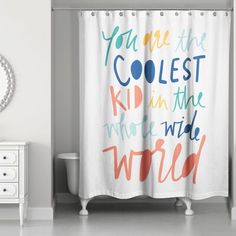 a bathroom with a shower curtain that says you are the coolest kid in the world