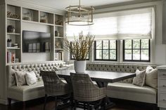 a table and chairs in a room with built - in bookshelves