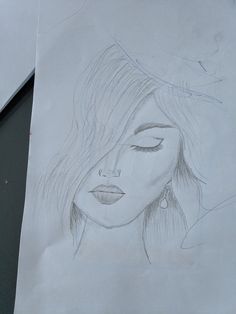 a pencil drawing of a woman's face with eyes closed and her hair blowing in the wind