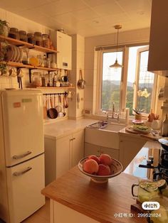 a bowl of fruit sitting on top of a kitchen counter